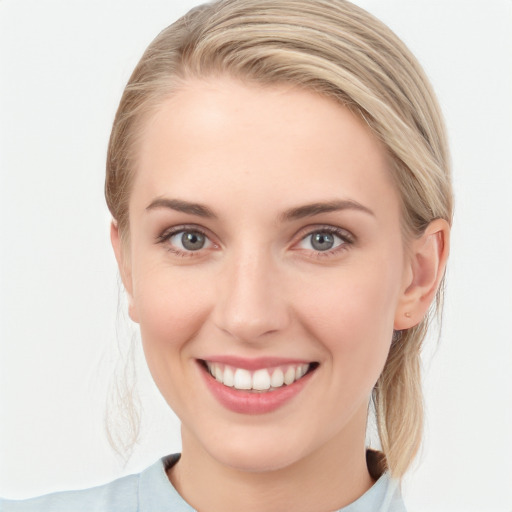 Joyful white young-adult female with medium  brown hair and blue eyes