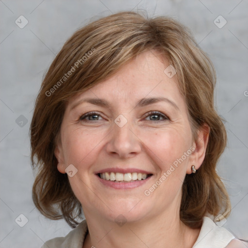 Joyful white adult female with medium  brown hair and grey eyes