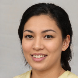 Joyful latino young-adult female with medium  brown hair and brown eyes