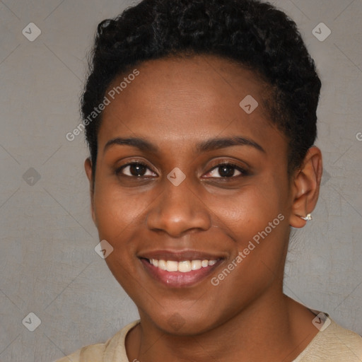 Joyful black young-adult female with short  black hair and brown eyes