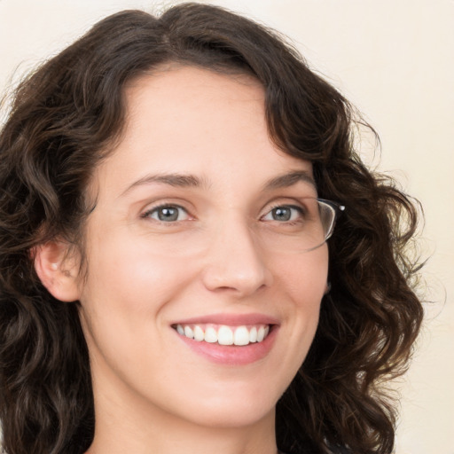 Joyful white young-adult female with long  brown hair and green eyes