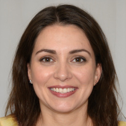 Joyful white young-adult female with medium  brown hair and brown eyes