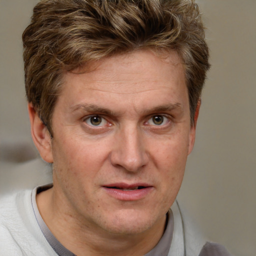 Joyful white adult male with short  brown hair and grey eyes