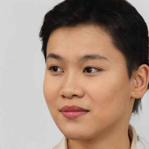 Joyful asian young-adult female with short  black hair and brown eyes