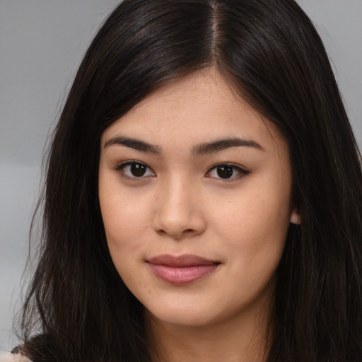 Joyful asian young-adult female with long  brown hair and brown eyes