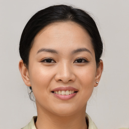 Joyful asian young-adult female with medium  brown hair and brown eyes