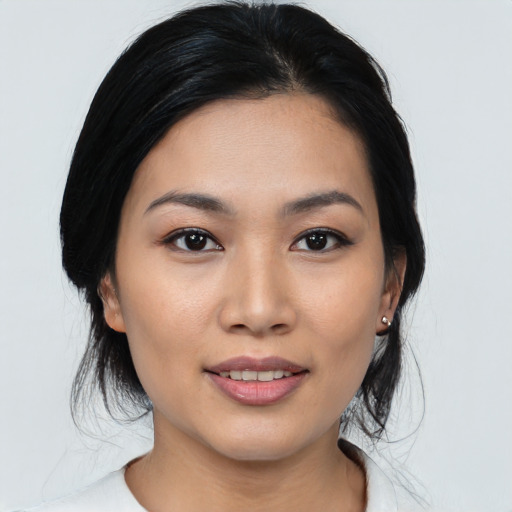 Joyful asian young-adult female with medium  black hair and brown eyes