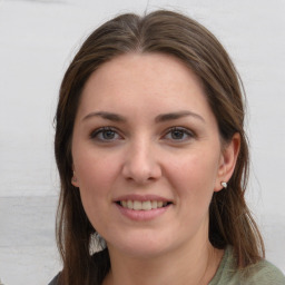 Joyful white young-adult female with long  brown hair and grey eyes