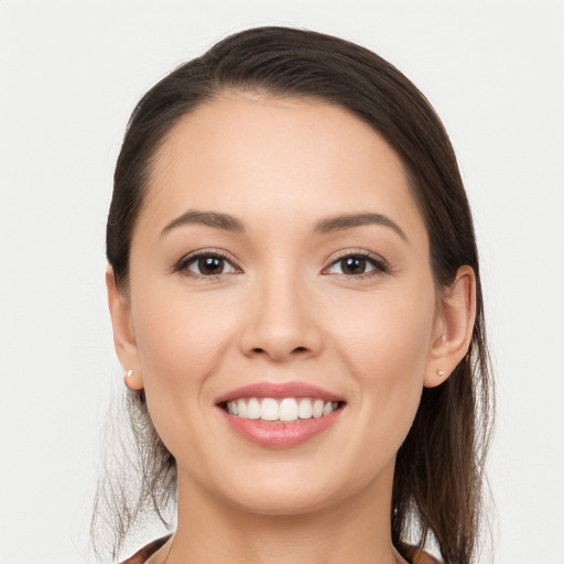 Joyful white young-adult female with long  brown hair and brown eyes