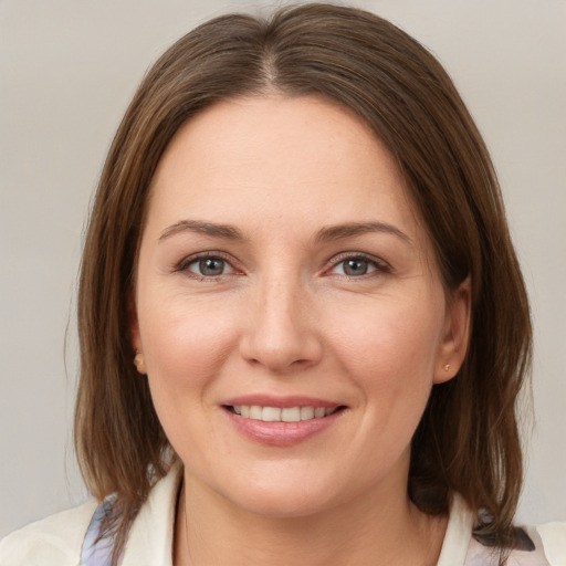 Joyful white young-adult female with medium  brown hair and grey eyes