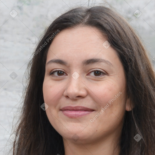 Joyful white adult female with long  brown hair and brown eyes