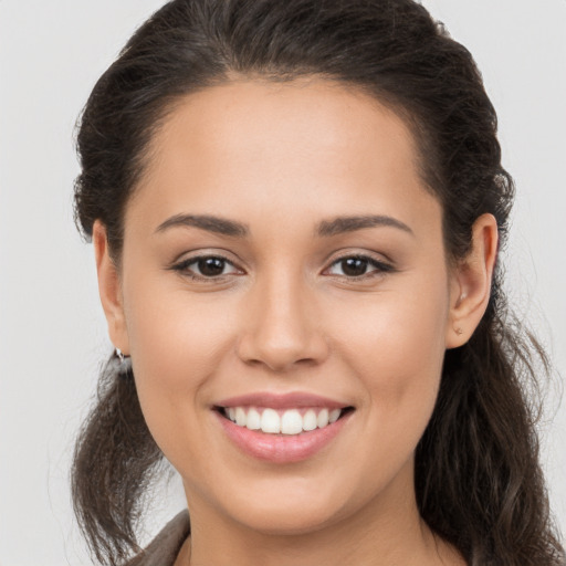 Joyful white young-adult female with long  brown hair and brown eyes