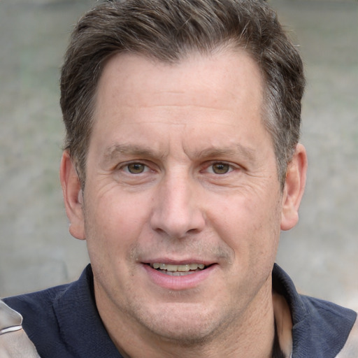 Joyful white adult male with short  brown hair and grey eyes