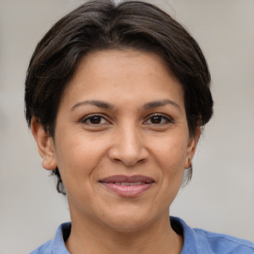 Joyful white adult female with medium  brown hair and brown eyes