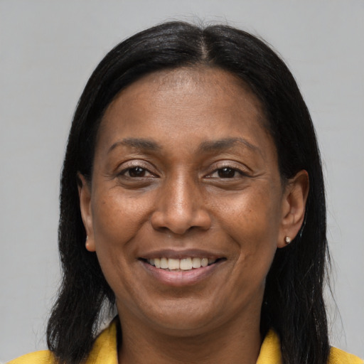 Joyful latino adult female with long  brown hair and brown eyes