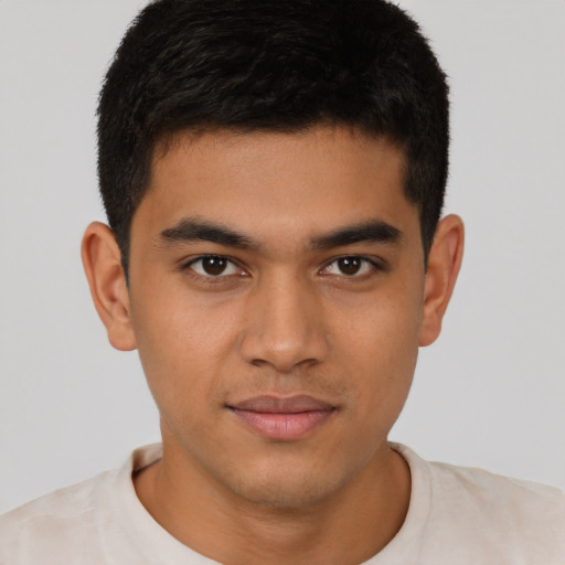 Joyful latino young-adult male with short  brown hair and brown eyes