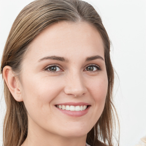 Joyful white young-adult female with long  brown hair and blue eyes