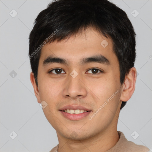 Joyful asian young-adult male with short  brown hair and brown eyes