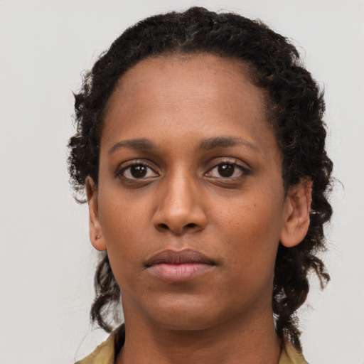 Neutral black young-adult female with long  brown hair and brown eyes