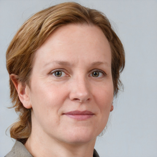 Joyful white adult female with medium  brown hair and blue eyes