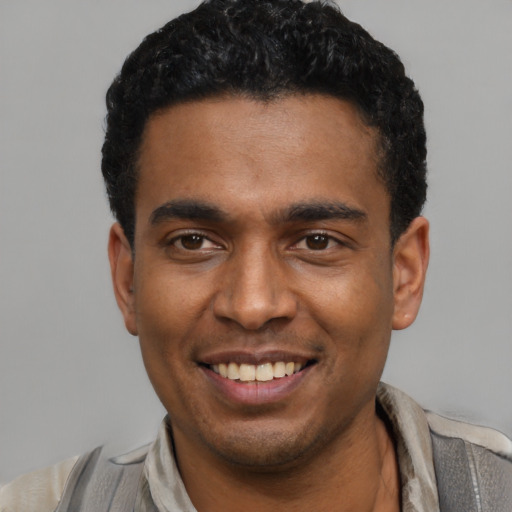 Joyful latino young-adult male with short  black hair and brown eyes