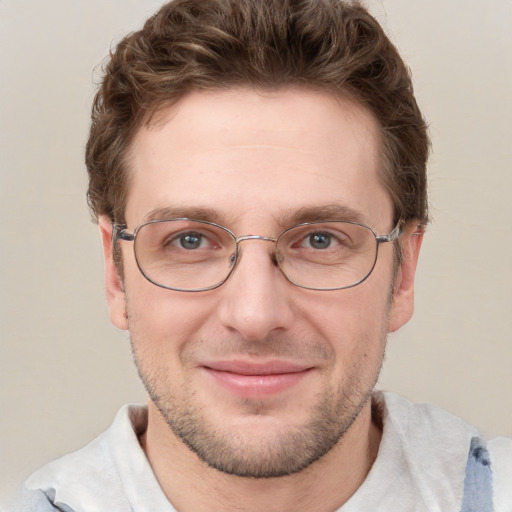 Joyful white adult male with short  brown hair and blue eyes