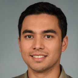 Joyful white young-adult male with short  black hair and brown eyes