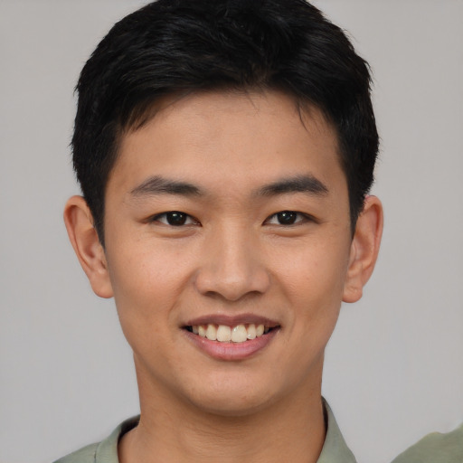 Joyful asian young-adult male with short  brown hair and brown eyes