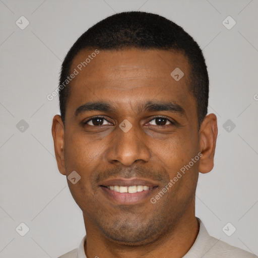 Joyful black young-adult male with short  black hair and brown eyes