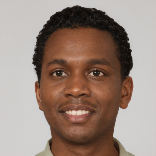 Joyful black young-adult male with short  brown hair and brown eyes