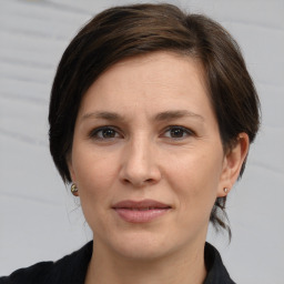 Joyful white adult female with medium  brown hair and brown eyes