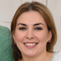 Joyful white young-adult female with medium  brown hair and green eyes