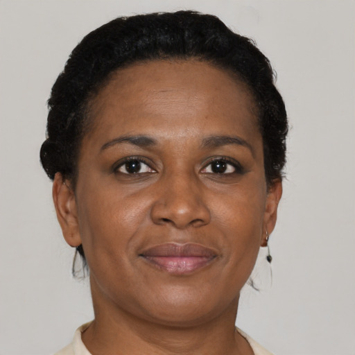Joyful black adult female with short  brown hair and brown eyes