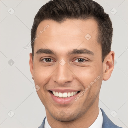 Joyful white young-adult male with short  brown hair and brown eyes