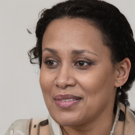 Joyful black adult female with medium  black hair and brown eyes