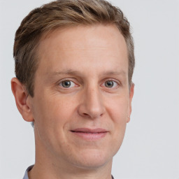 Joyful white adult male with short  brown hair and grey eyes