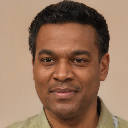 Joyful latino adult male with short  black hair and brown eyes