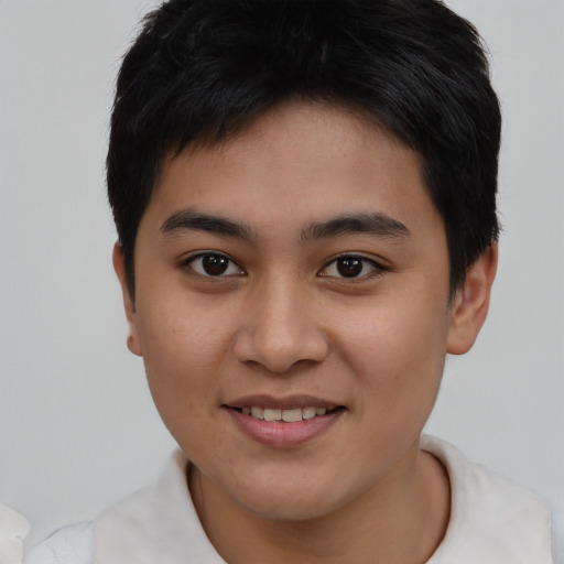 Joyful asian young-adult male with short  brown hair and brown eyes