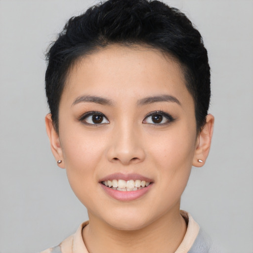 Joyful asian young-adult female with short  brown hair and brown eyes