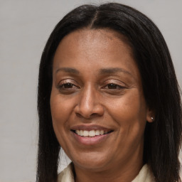 Joyful black adult female with long  brown hair and brown eyes