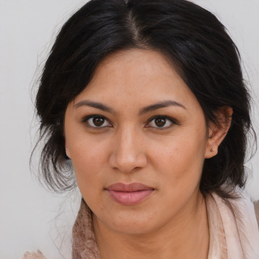 Joyful asian young-adult female with long  brown hair and brown eyes