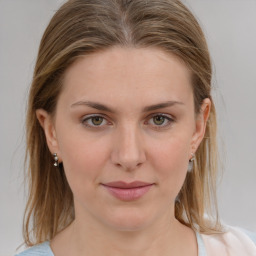 Joyful white young-adult female with medium  brown hair and grey eyes