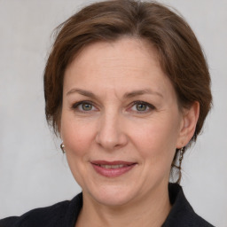 Joyful white adult female with medium  brown hair and grey eyes