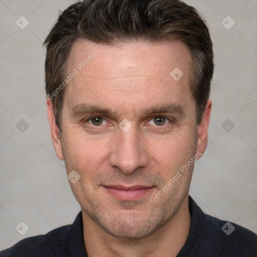 Joyful white adult male with short  brown hair and grey eyes