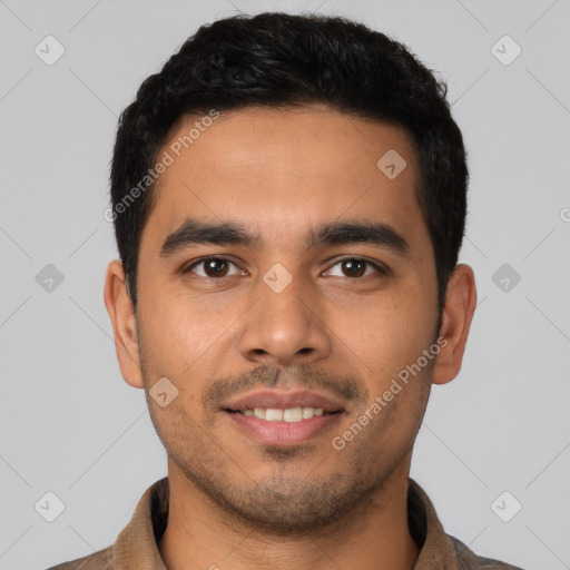 Joyful latino young-adult male with short  black hair and brown eyes