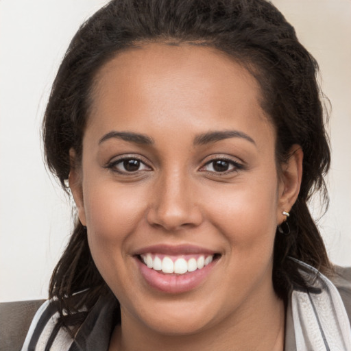 Joyful white young-adult female with long  brown hair and brown eyes