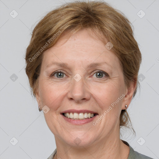 Joyful white adult female with medium  brown hair and grey eyes