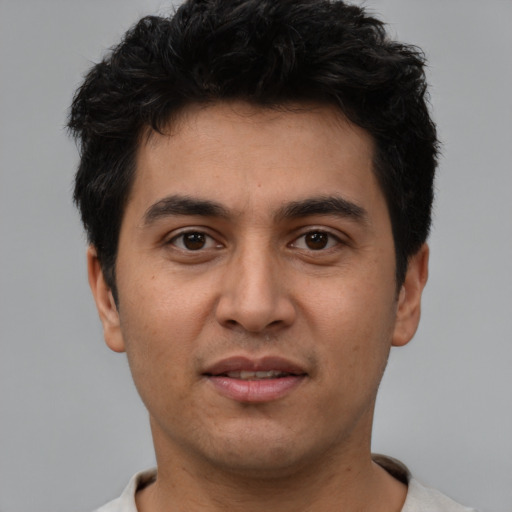 Joyful white young-adult male with short  black hair and brown eyes
