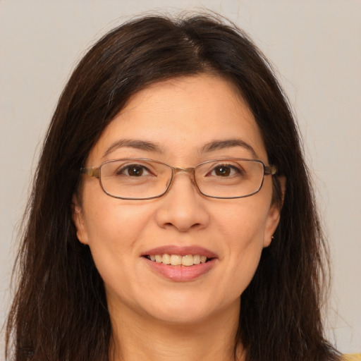 Joyful white adult female with long  brown hair and brown eyes