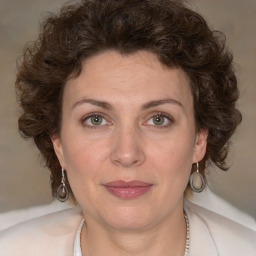 Joyful white young-adult female with medium  brown hair and green eyes